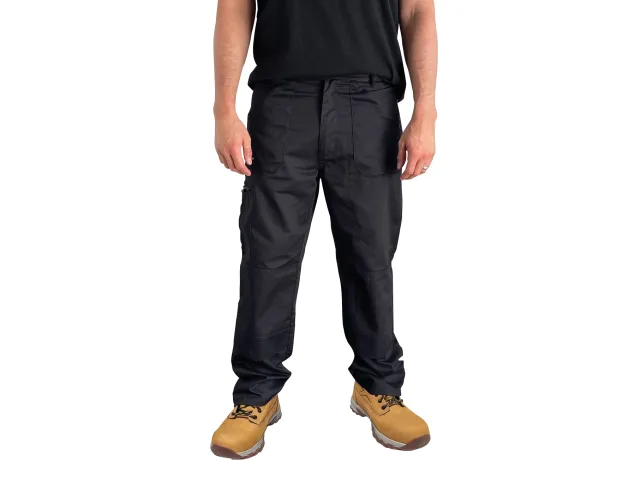 Person wearing black pants and tan boots on a white background
