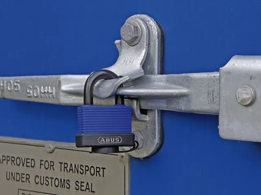 Lock on a metal gate with a blue background