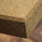 Close-up of a cork board with a blurred background