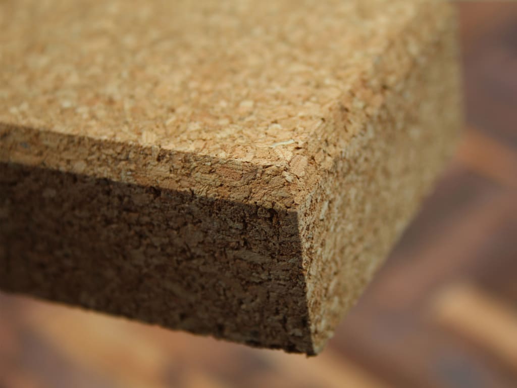 Close-up of a cork board with a blurred background