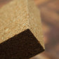 Close-up of a corner of a stone or concrete block with a blurred background