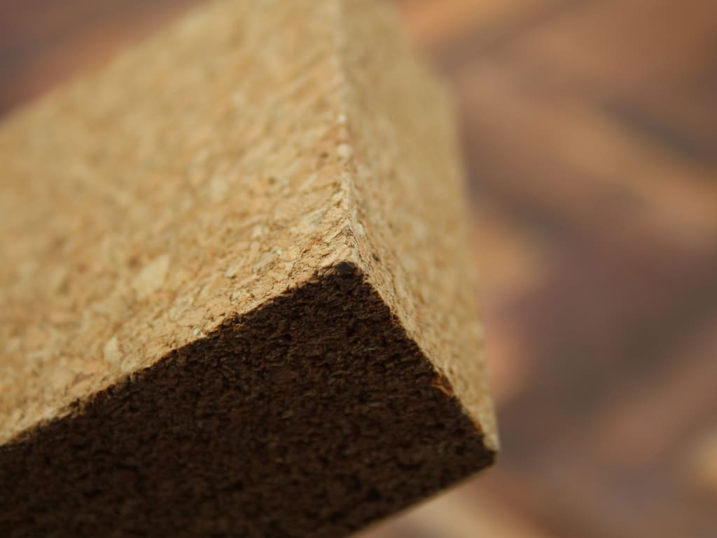 Close-up of a corner of a stone or concrete block with a blurred background