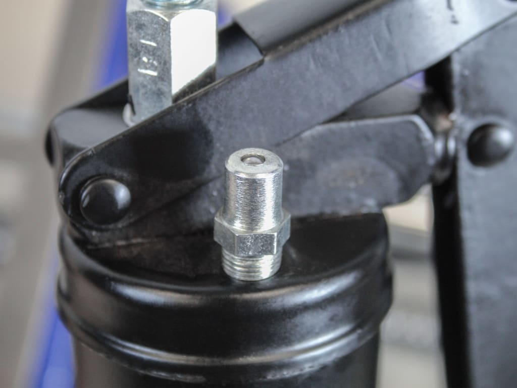 Close-up of a mechanical component with a black housing and metal fitting.