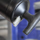 Close-up of a black lever mechanism with a blurred background