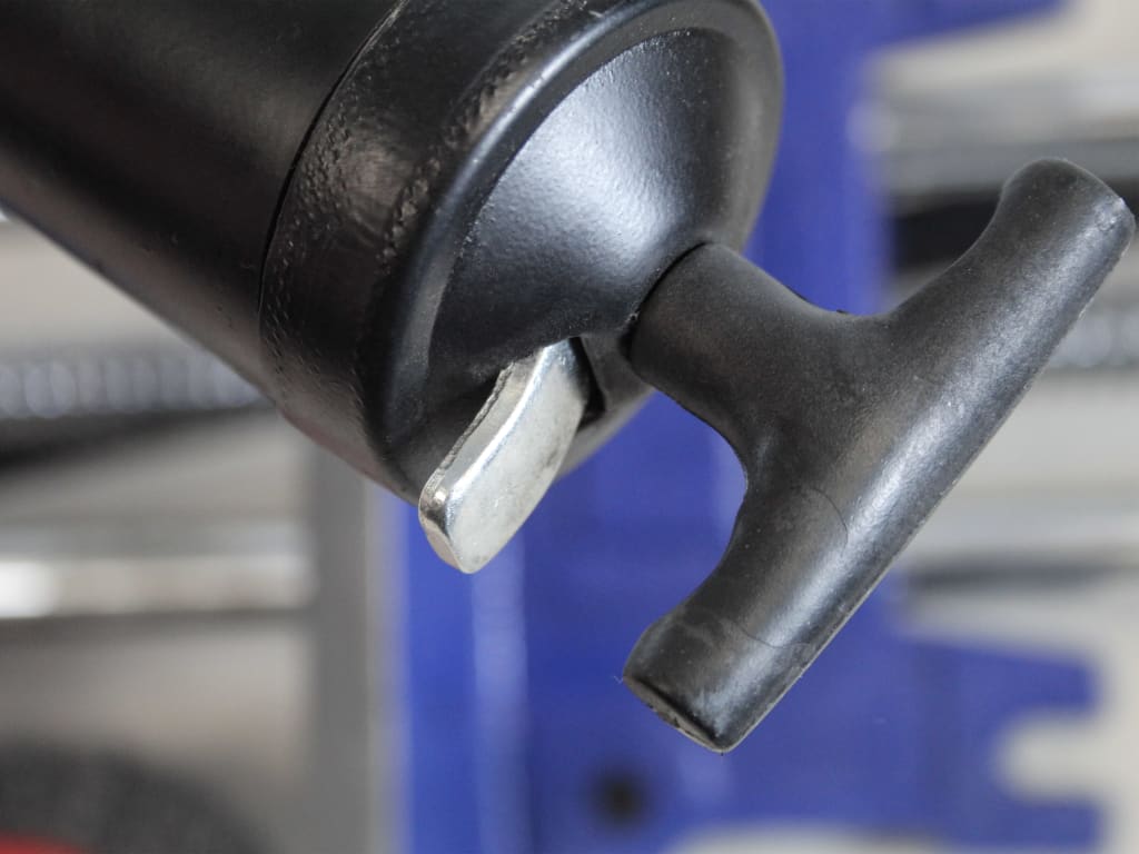 Close-up of a black lever mechanism with a blurred background