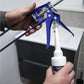 Person using a caulking gun to apply silicone sealant to a bathroom fixture.
