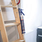 Wooden ladder with a caulking gun on a white background