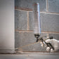Person using a caulking gun on a brick wall