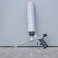 Foam gun with foam cartridge on a gray background