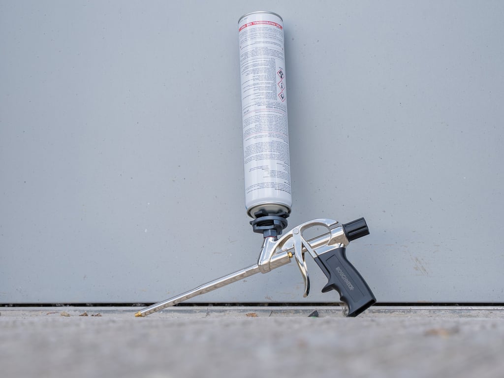 Foam gun with foam cartridge on a gray background