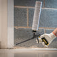 Person applying silicone sealant to a joint between tiles.