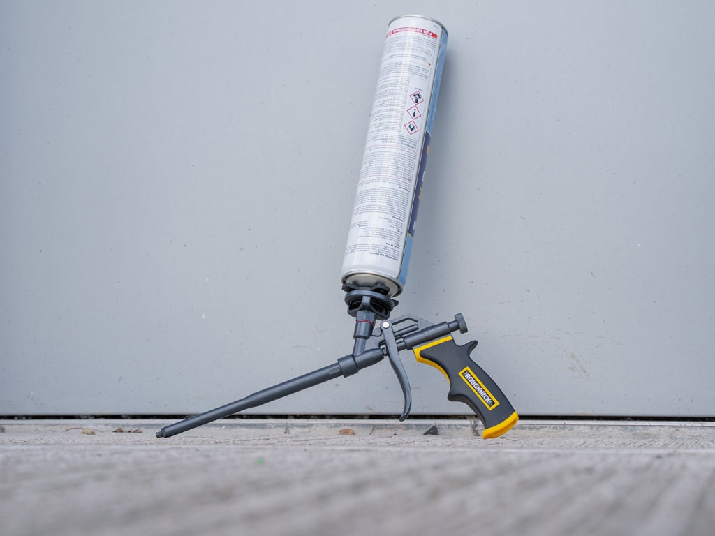 Foam gun with a foam cartridge on a gray background