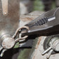 Multitool with various tools attached to a metal surface