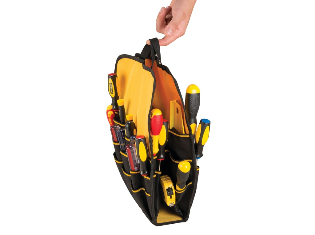 A black and yellow tool organizer pouch filled with various hand tools, held open by a person's hand against a white background.