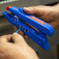 Blue tool with red cap being used by a person on a blurred background