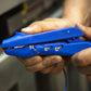 Person holding a blue stapler with a blurred background