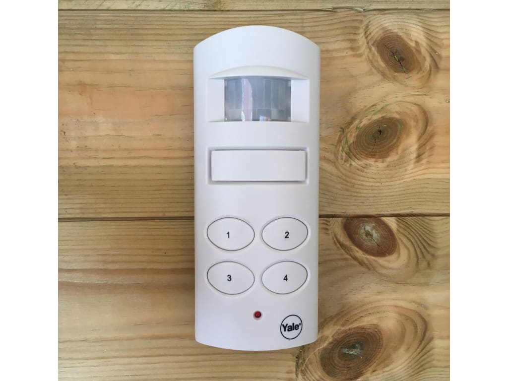 White electronic device with buttons on a wooden surface