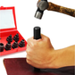 Hand holding a black tool next to a red tool set with sockets and a hammer on a white background