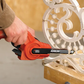 Person using a power tool on decorative metalwork