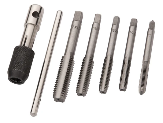 Set of metal threading tools on a white background