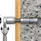 Drill bit attached to a drill on a concrete surface with measurement symbols.