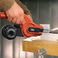 Person using a BLACK+DECKER power tool on a wooden surface