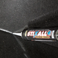Stixall Extreme Power adhesive tube on a black surface