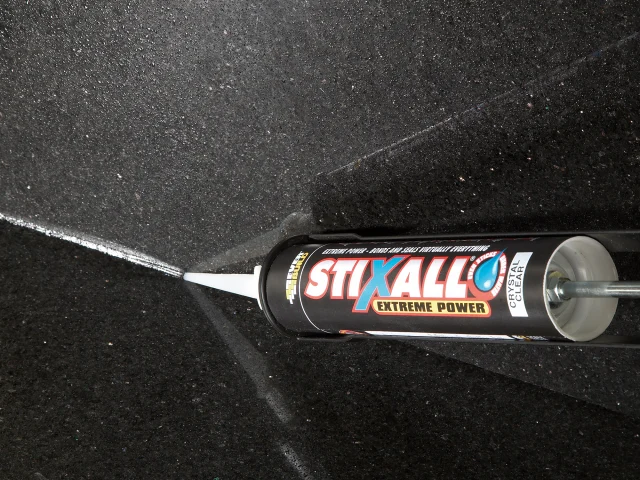 Stixall Extreme Power adhesive tube on a black surface
