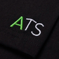 Black fabric with 'ATS' embroidered in green and white