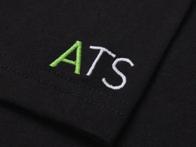 Black fabric with 'ATS' embroidered in green and white