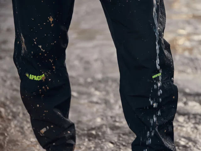 Black pants with visible branding on a textured ground