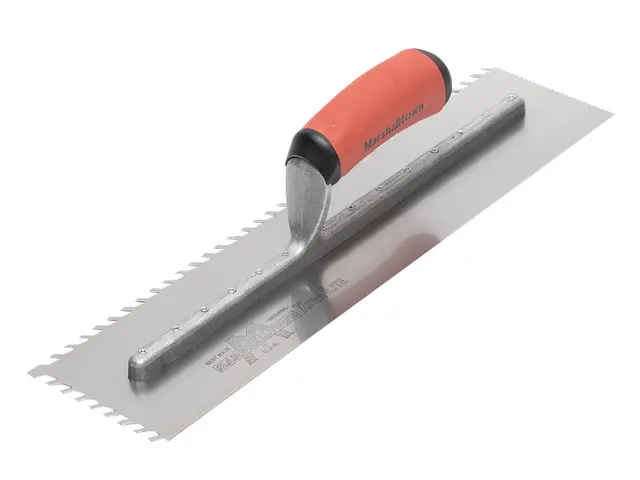 Metal trowel with red handle on a white background