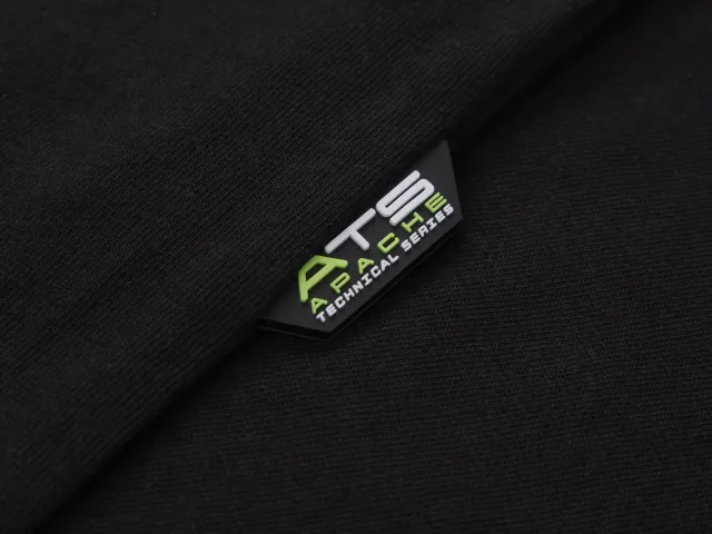 Close-up of a black fabric with a logo label on a dark background