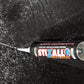 Stixall extreme power adhesive tube on a black textured surface