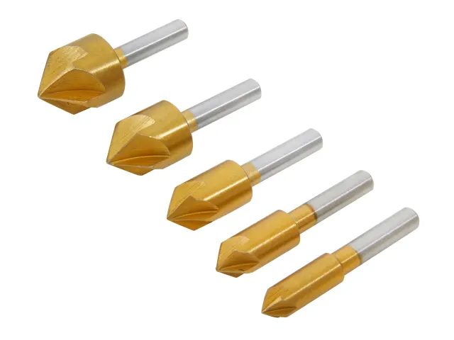 Set of five gold and silver drill bits on a white background