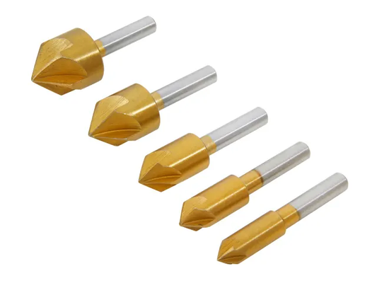 Set of five gold and silver drill bits on a white background