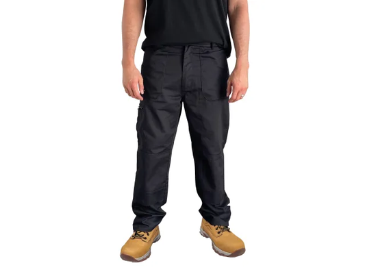 Person wearing black pants and tan boots on a white background
