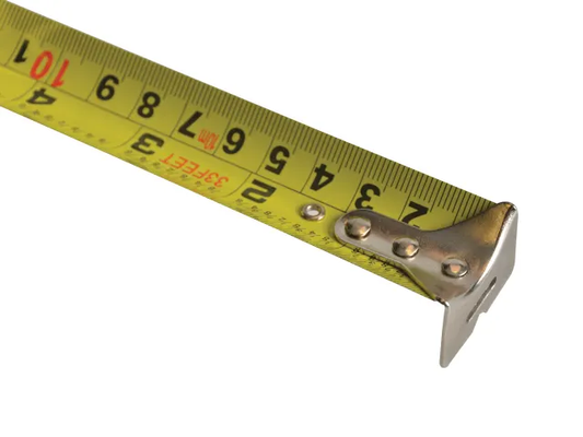 Yellow measuring tape with metal corner on a white background