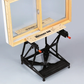 Wooden window frame on a black adjustable stand against a gray background