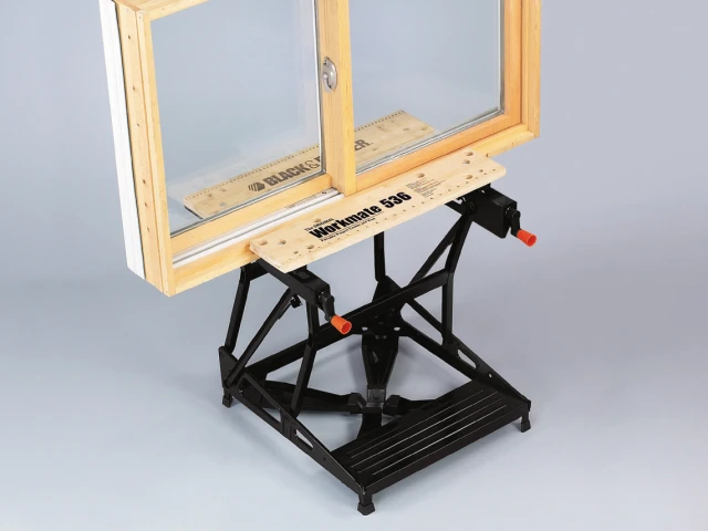 Wooden window frame on a black adjustable stand against a gray background