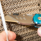 BlueSpa pocket knife being used to cut cardboard