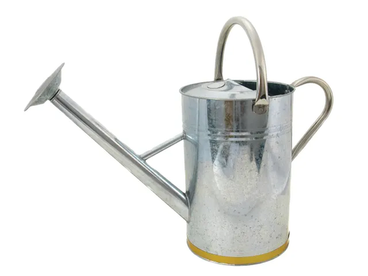 Metal watering can on a white background