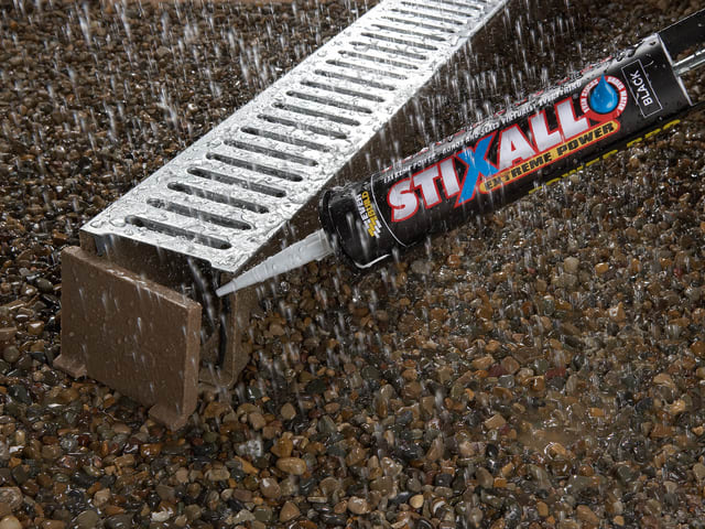 Stix All sealant gun applying sealant to a metal drain cover on a textured surface.
