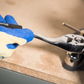 Hand using a wrench on a mechanical part with a blurred background