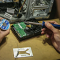 Person working on a computer internal components with a screwdriver and thermal paste.