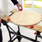 Woodworking workbench with adjustable legs and a circular wooden platform, featuring the Black & Decker brand.