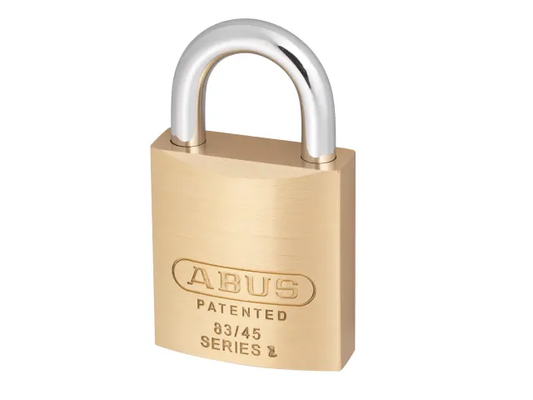 Brass padlock with silver shackle on a white background