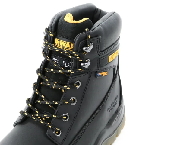 Black DeWalt work boot with yellow accents on a white background
