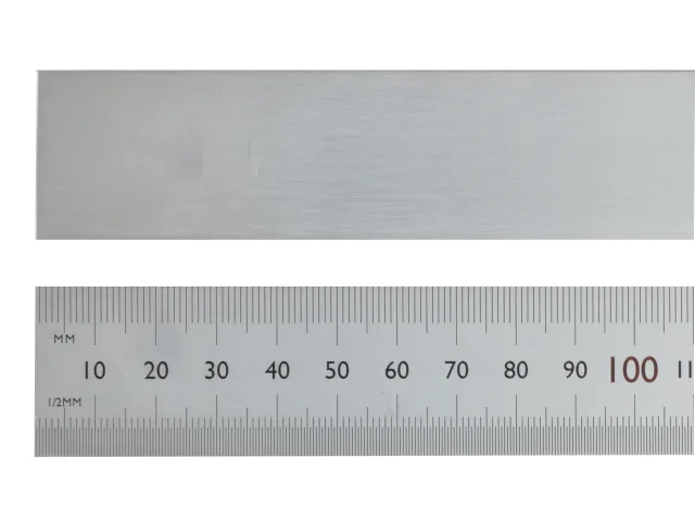 Metal ruler with measurement markings on a white background