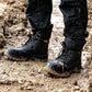 Black boots and pants on a muddy ground